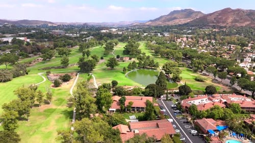 Enjoy a Stunning Aerial View of a Sunny California Golf Course Nestled in Beautiful Landscapes