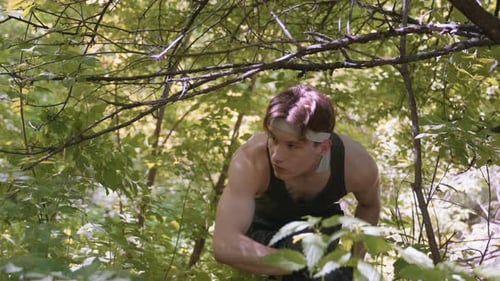 Soldier Walking and Bending Under Low Hanging Branch