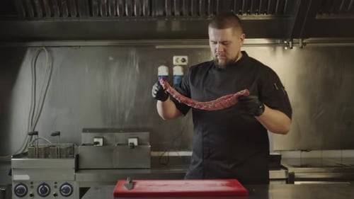 Le chef prépare des côtes crues pour les griller