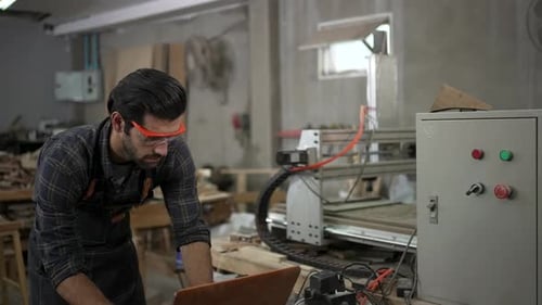 Carpenter is working at workshop.