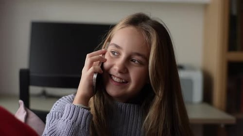 Smiling Girl Talking on the Phone Indoors