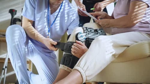 Fitting Knee Brace in Hospital with Medical Staff