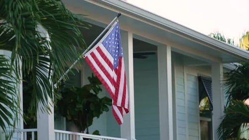 American National Flag Waving in Front Yard of Florida Private House Aerial View of USA Stars and