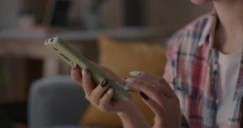 Young Adult Using a Smartphone Indoors