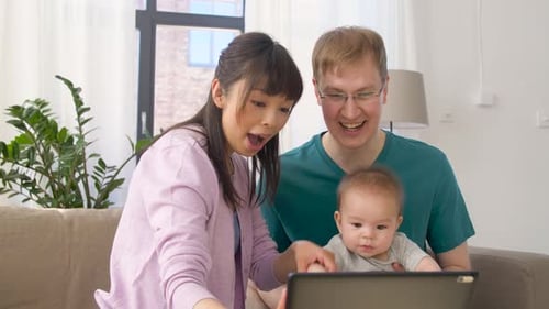 Happy Family Enjoys Tablet Time Together at Home