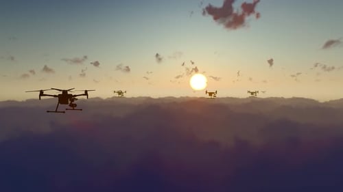 Modern Drones Flying Silhouette Over Clouds at Sunset