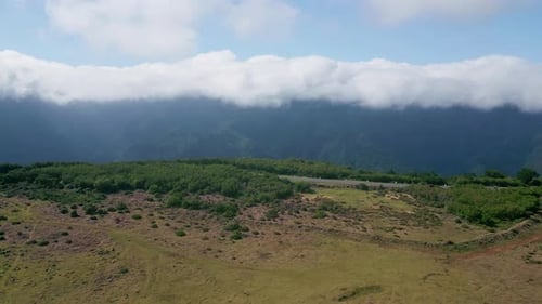 Aerial Breathtaking Mountain Landscape in Dense Green Forest Under Cloudy Sky