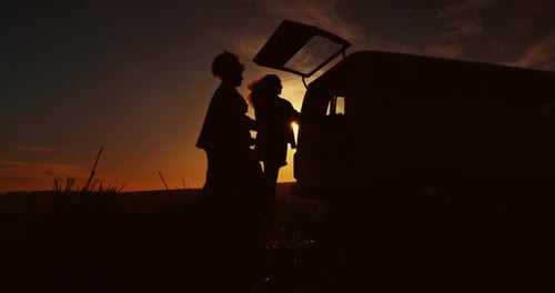 Road trip, sunset and silhouette of people in car for adventure, journey and freedom outdoors