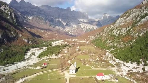 Looking down Theth valley with Theth church with the Albania alps in the background at sunrise