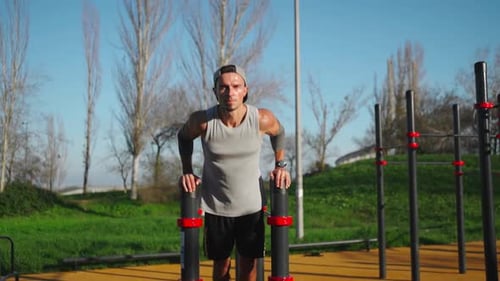 Man Doing Parallel Bar Exercises Outside