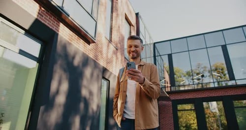 Man Using Smartphone Outside Urban Building