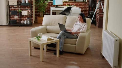 Woman Video Calling on Laptop from Modern Apartment