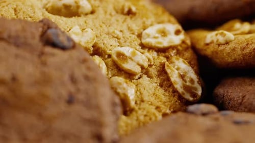 Close Up on Black and Blue Background Flat Plate with Cookie Cookies Lying Chaotically on the Table
