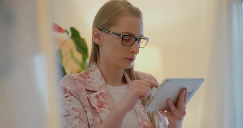 Woman Using Tablet Computer Device Indoors