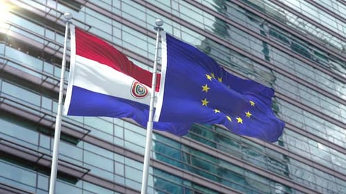 Paraguay and European Union Flags Waving in Front of Modern Building