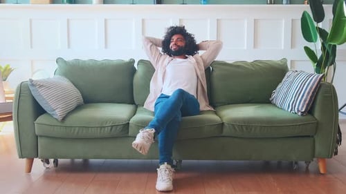 Young Adult Relaxing on Couch at Home
