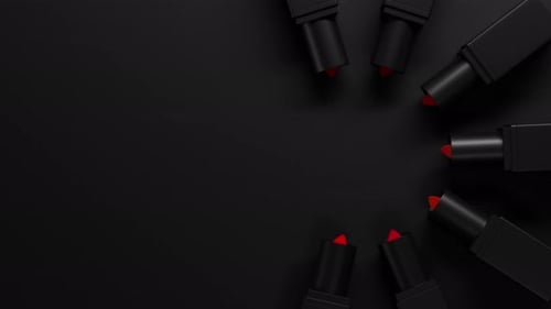 Top View on Red Lipstick Set Twists Up From Black Tubes on Dark Backdrop Lipstick Group Extend