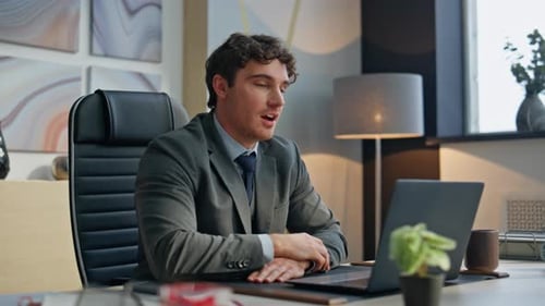Friendly Man Greeting Video Waving Hand at Office Using Laptop Camera Closeup