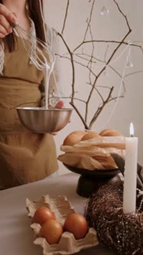 Woman Whisks Ingredients in Bowl at Festive Table