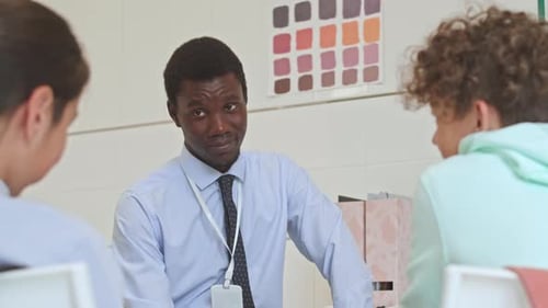 Adult Tutoring Students in Classroom Setting