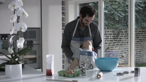 Father and Son Baking Cookies in Kitchen