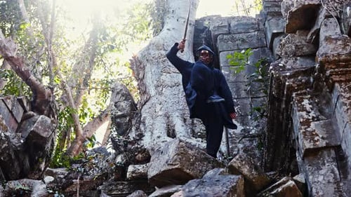 Man With Mask Doing Sword Stances At Ruins