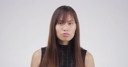 Young Woman's Neutral Expression, Close Up Portrait