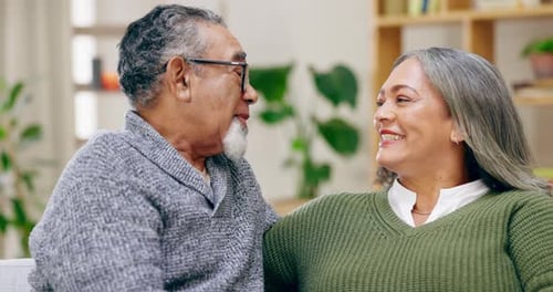 Senior Couple Talking and Smiling Together at Home