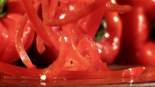 Sliced Red Bell Peppers Falling in Slow Motion