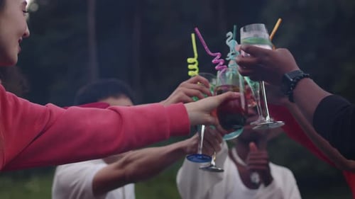 Young Multiracial Friends Clinking Their Fancy Cocktails Near the Barbecue Grill at the Cheerful