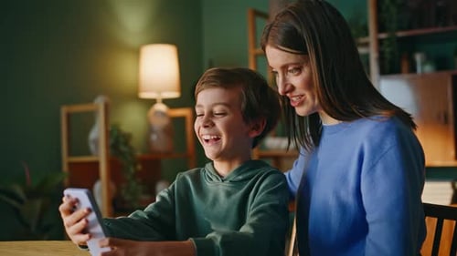 Woman Child Watching Cellphone Family Weekend Closeup Little Boy Laughing