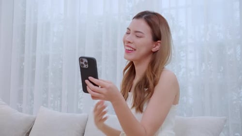 Woman Using Smartphone for Video Call at Home