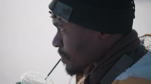 Young Man Drinking From a Plastic Cup