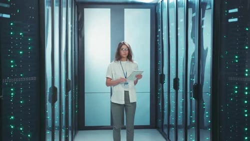 Woman Stands with Tablet in Server Room