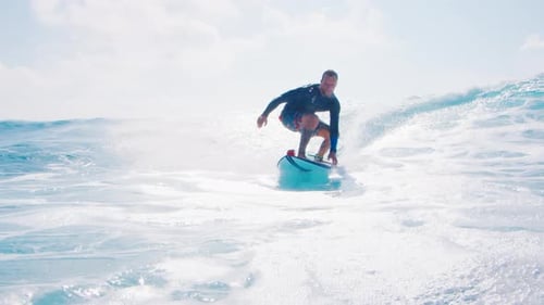 Man Surfs Ocean Wave in the Maldives