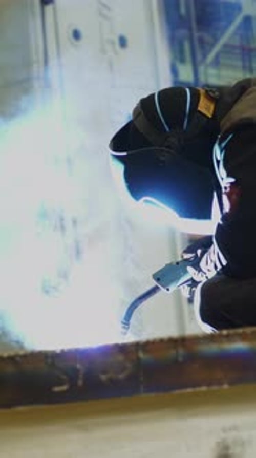Industrial Worker Welding Metal in Factory Stock Clip
