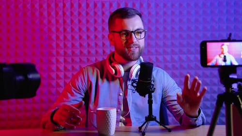 Man Recording a Podcast in a Colorful Studio