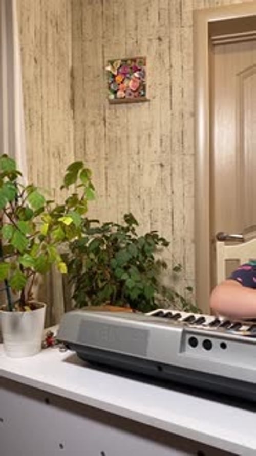 Girl Learning Keyboard with Instructor at Home