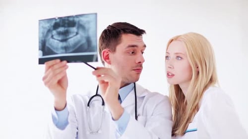 Doctors examining x-ray prints sharing medical advice in a hospital clinic