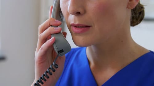 Hispanic healthcare professional on a phone call at the hospital office