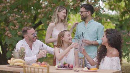 Friends Gathering Outside Enjoying Food and Drinks