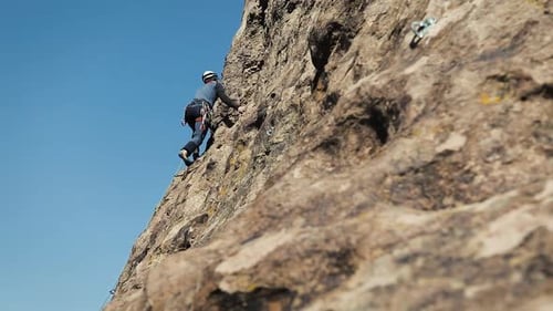 Man Athlette Climbing on the High Rock