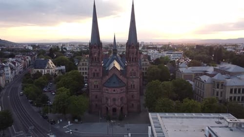Aerial tracking shot of catholic church Johanneskirche in gothic old town of Freiburg im Breisgau du