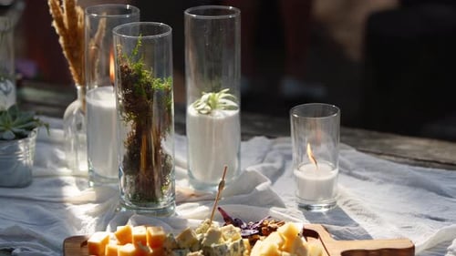 Wedding Party Banquet Outdoors in Forest Dining Table Decorated in Boho Style with Candles White