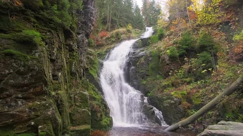 This Video Showcases a Beautiful Waterfall in a Tranquil Forest
