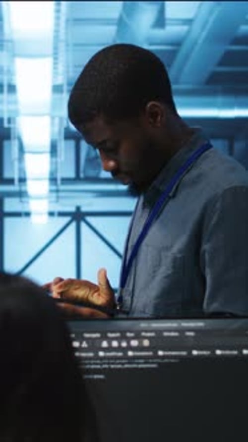 Vertical Video Manager Uses Tablet Supervising Team Programming in Data Center