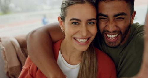 Cheerful Couple Smiling and Kissing Indoors