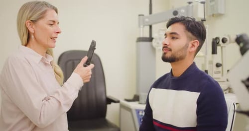 Man at the optometrist doing an eye exam to check his eyesight
