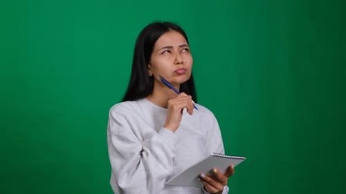 Woman Writing in Notebook on Green Screen