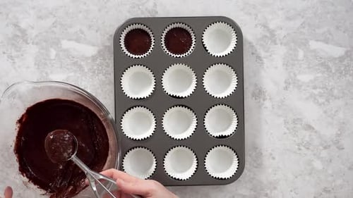 Flat Lay Scooping Chocolate Cupcake Dough Into the Cupcake Liners
